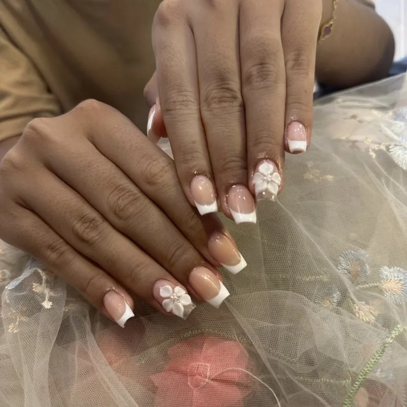 French tips finished with a 3D white flower accent